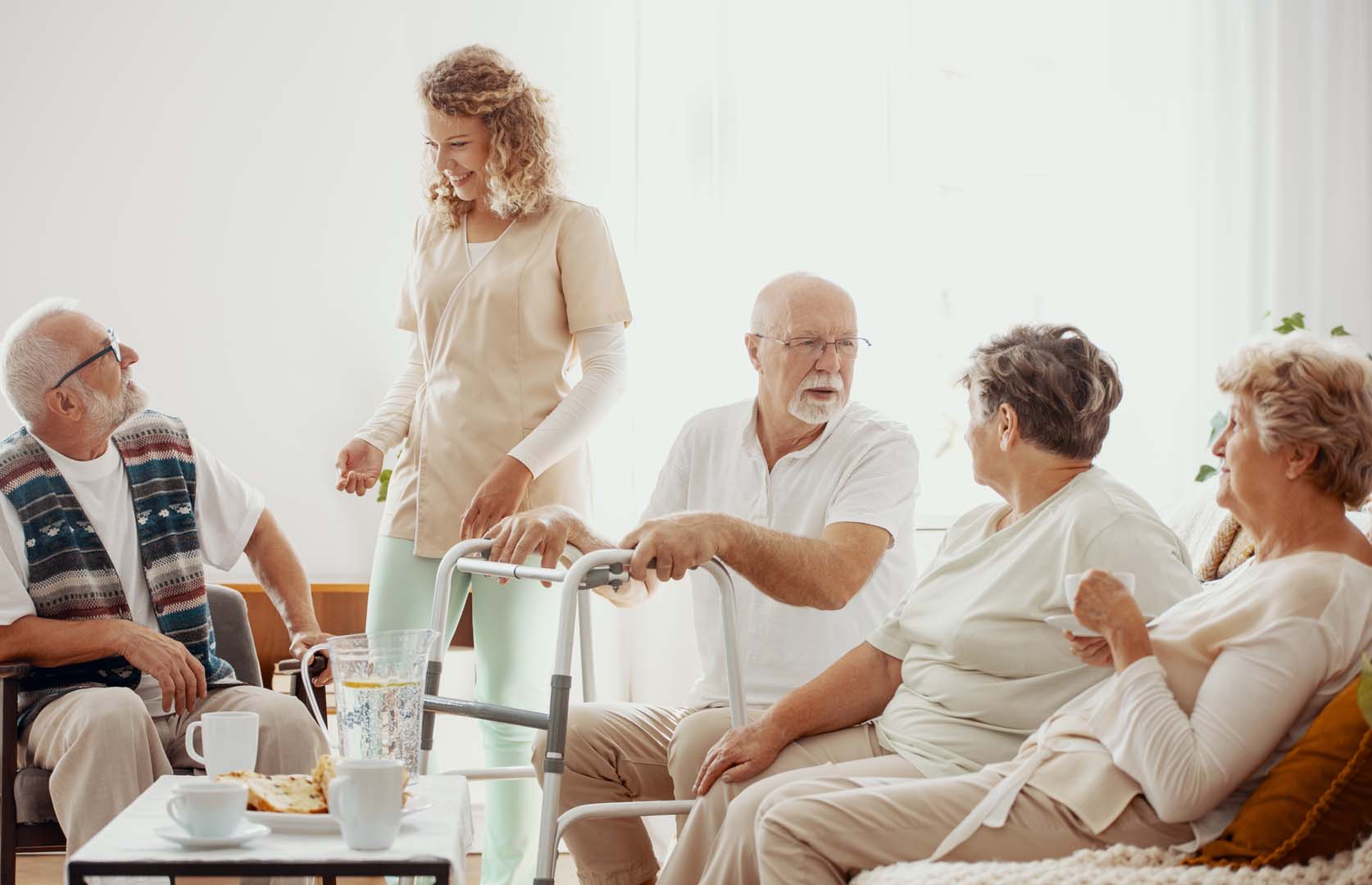 Elders spending time together in the common room of the care hom